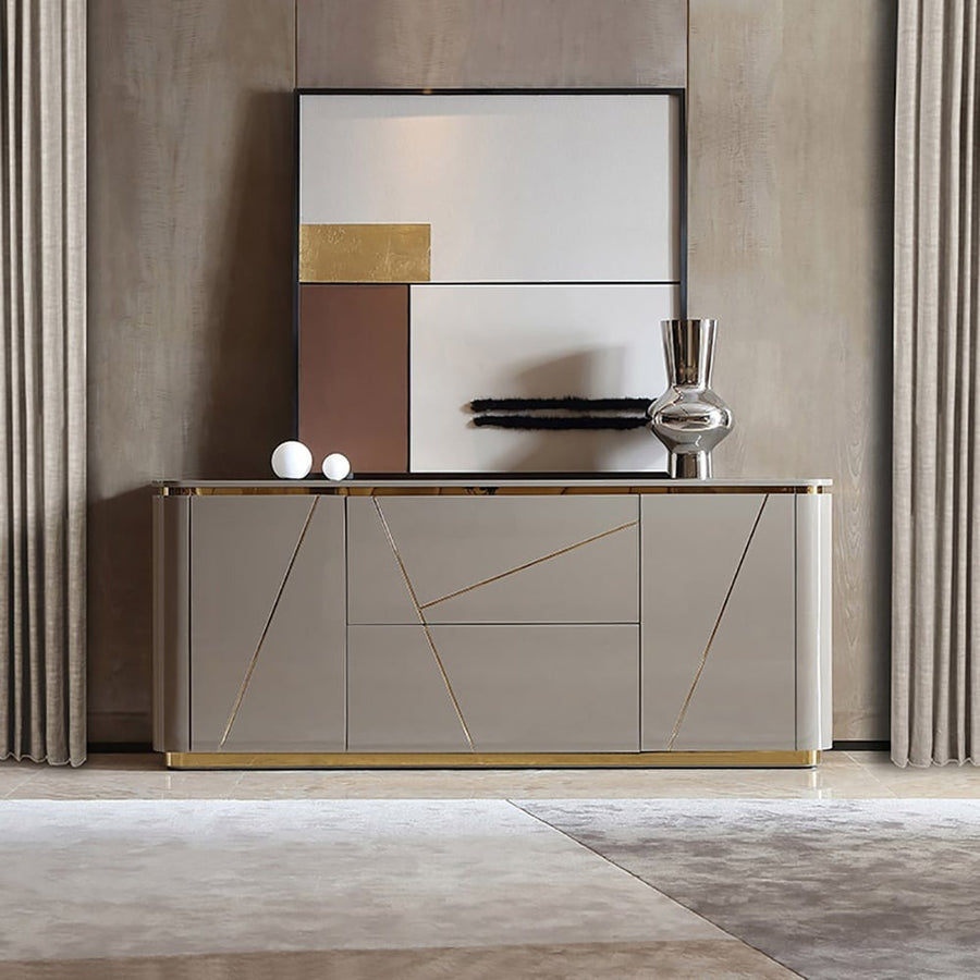 A modern grey sideboard with gold trimmings, featuring two drawers and two doors.