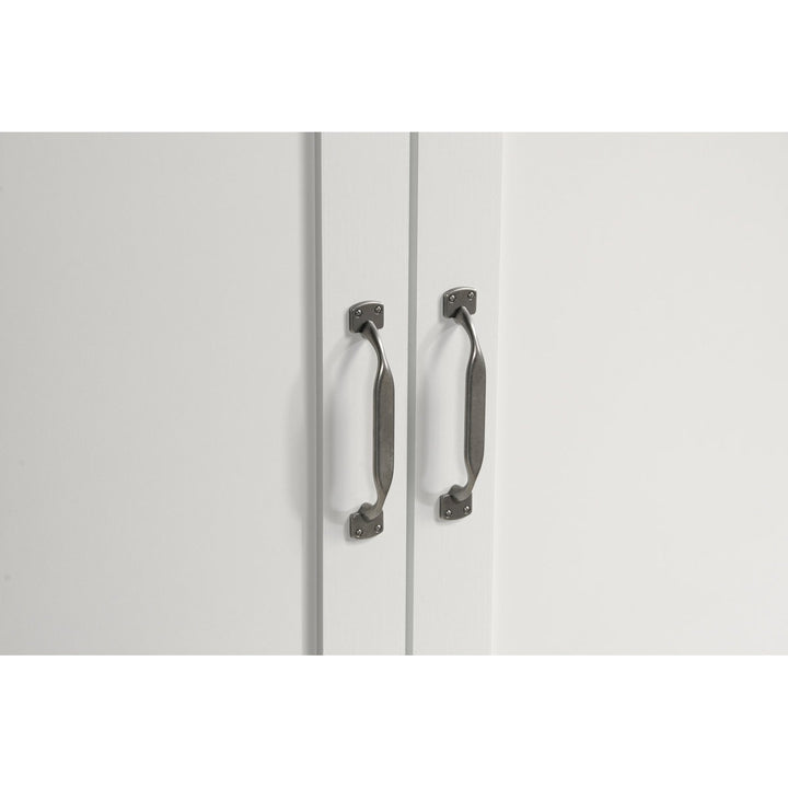 White cabinet with black handles on a white background