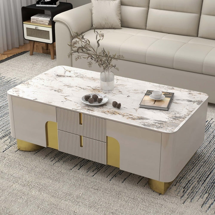 Beige Vista coffee table with premium stone top and spacious storage drawers, set in a modern living room