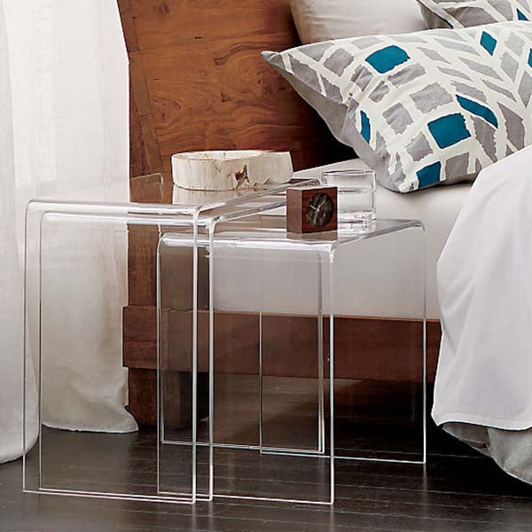 Clear acrylic nesting table near bed