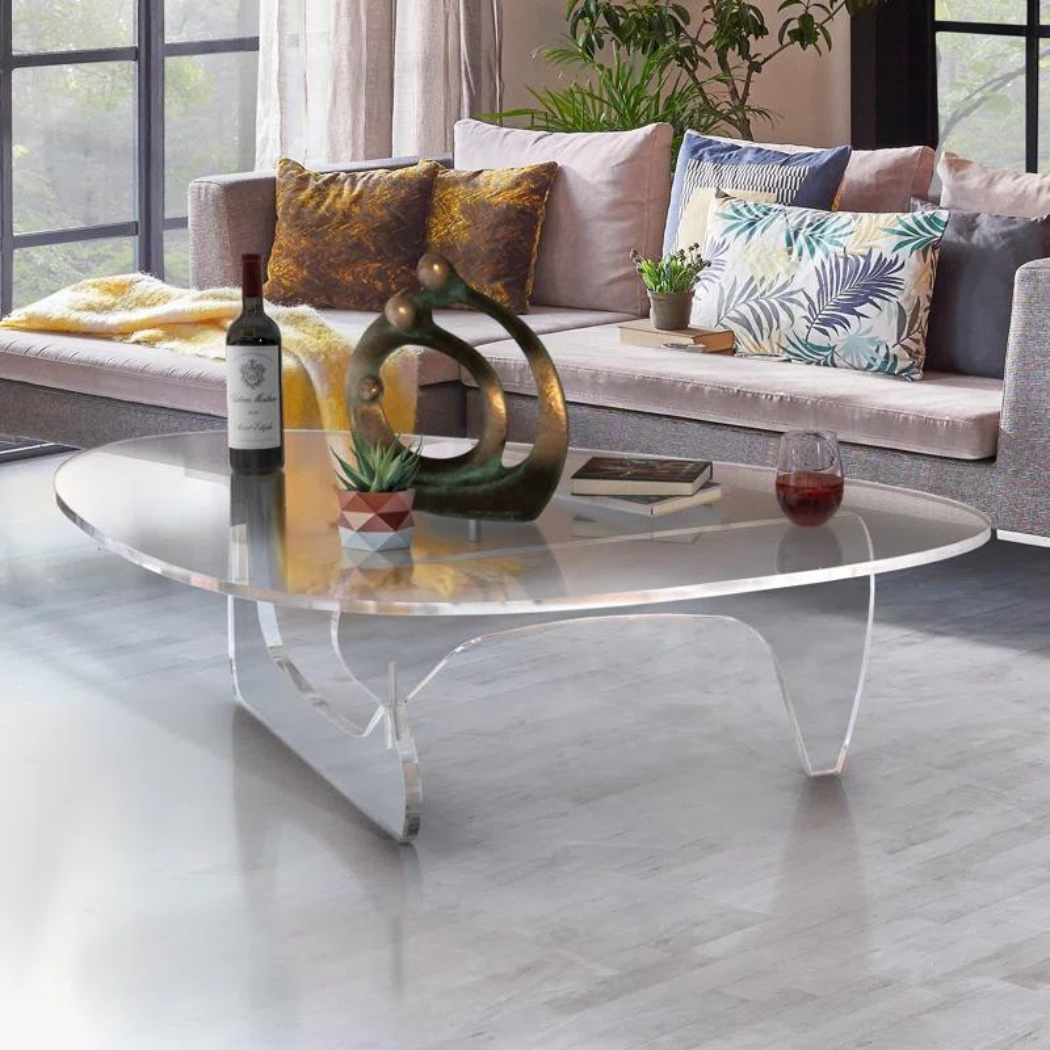 Clear acrylic Aurora coffee table paired with neutral decor, accentuating its optical lightness and minimal footprint.”
