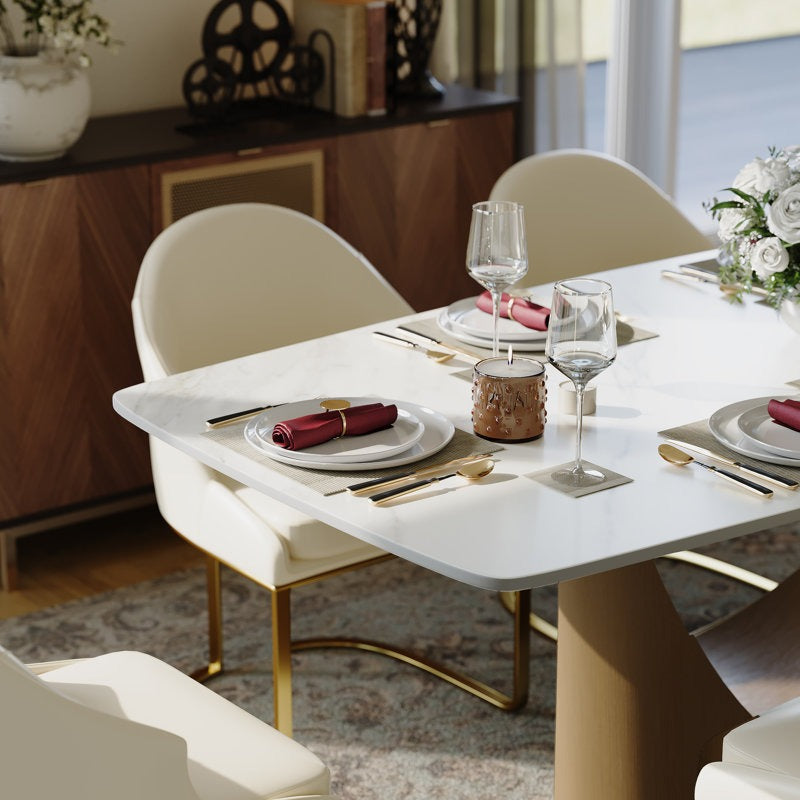 Dining table set with plates, glasses, and cutlery in a modern kitchen.