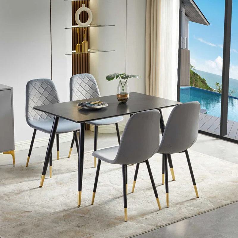 4-seater dining chairs with a modern design, featuring a black metal frame and fabric upholstery, arranged around a rectangular dining table with a modern, simple oak-look melamine veneer surface, set in a bright room with a pool view in the background.
