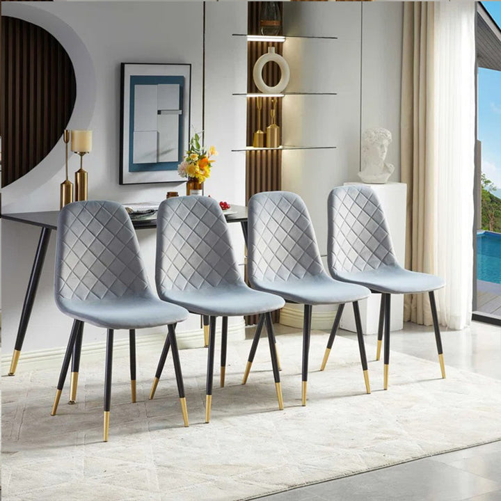 stylish four dining chair in grey upholstery fabric with black legs and golden accent
