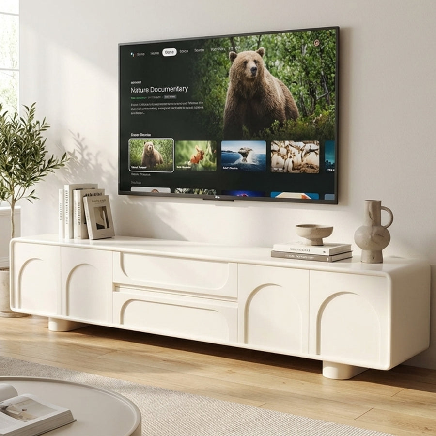 Modern living room with a white entertainment console and a TV displaying a nature documentary.