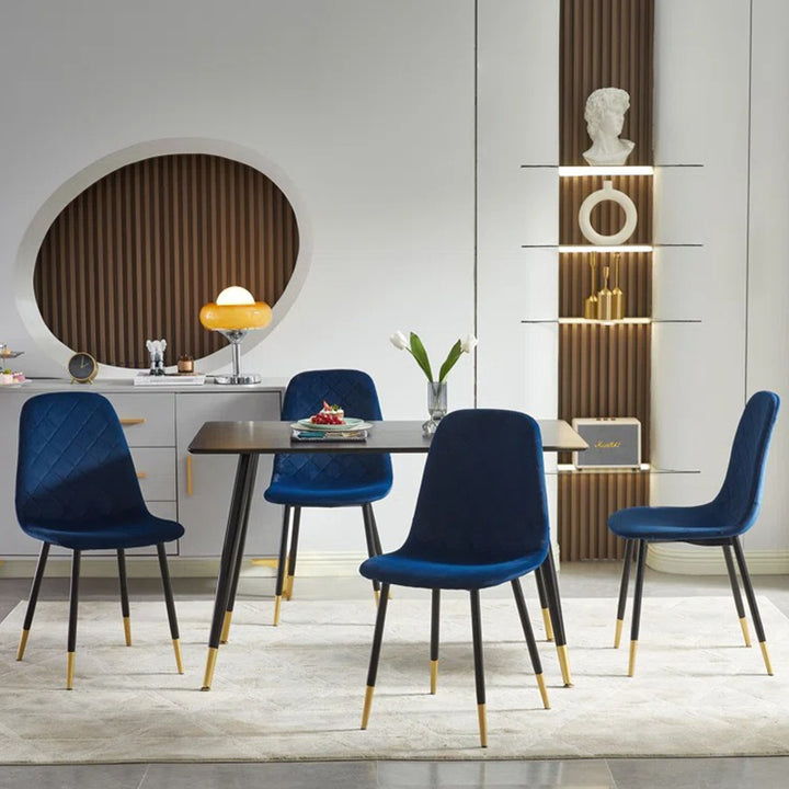 Modern blue 4 seater dining table with cushioned dining chairs.