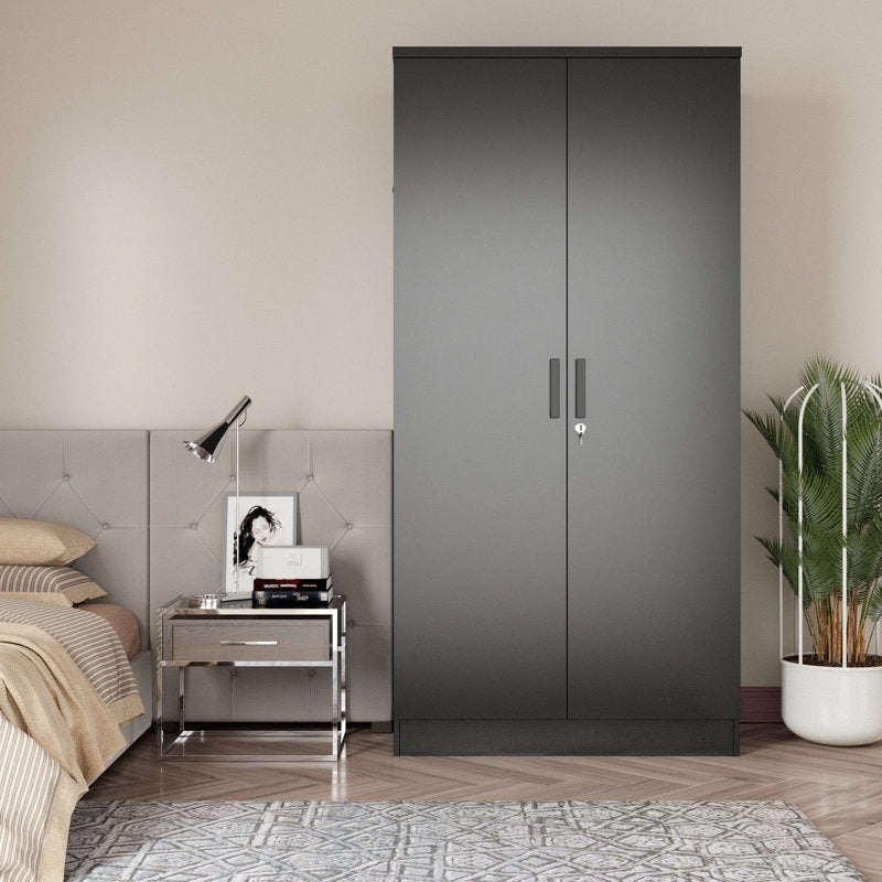 Stylish matte black 2-door wardrobe with sleek handles, placed in a room beside a bed and nightstand with a lamp.