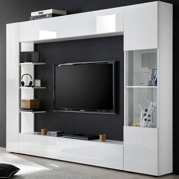 A white TV unit set with glass doors, featuring a flat-screen TV, various entertainment accessories, and a remote organizer.