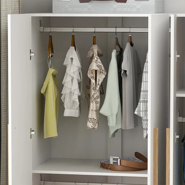 clothes hanging on a oval hanging rod of a modern white wardrobe