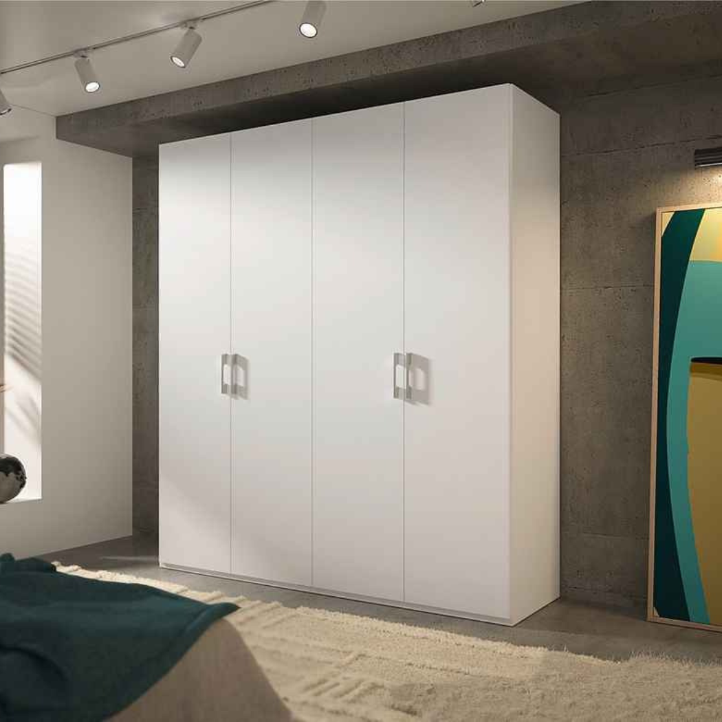 A stylish matte white 4-door wardrobe with matte silver handles, placed in a room with concrete walls