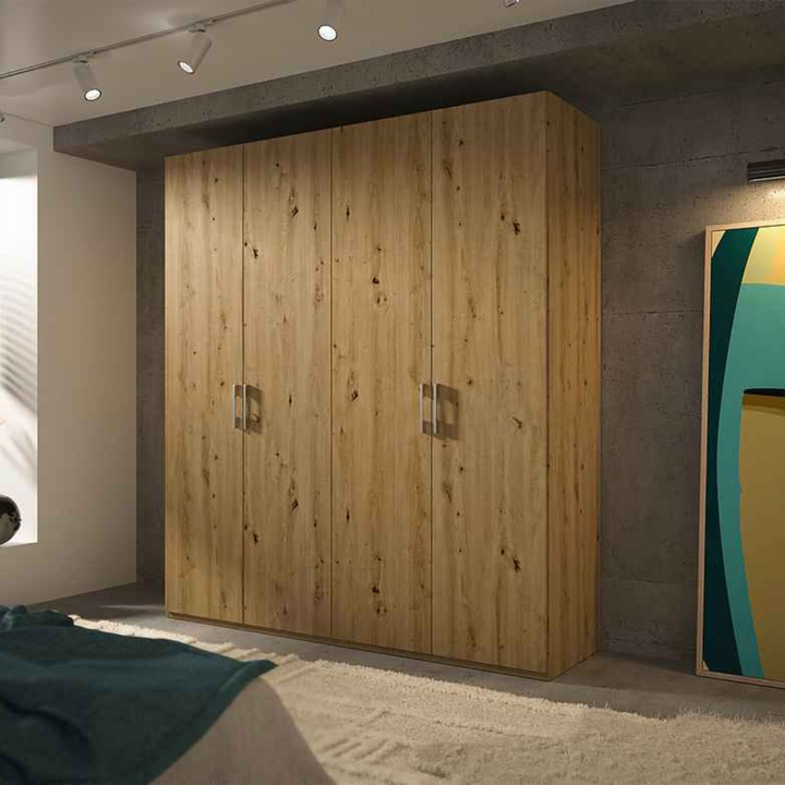 A beech-finished 4-door wardrobe with matte silver handles, situated in a room with a modern decor.