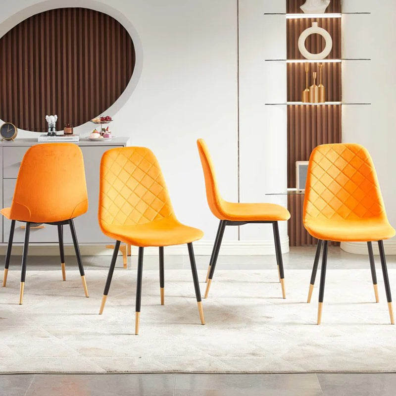 four ergonomically designed dining chairs upholstered in high-quality fabric that is smooth and soft to the touch