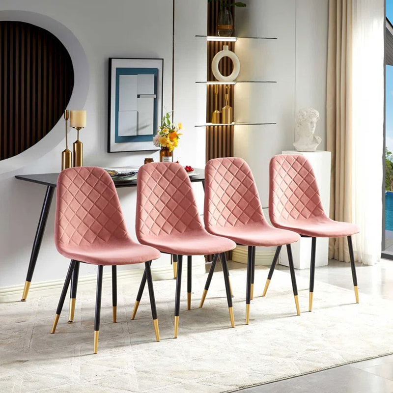 Modern four pink chairs with  black legs and gold accents 