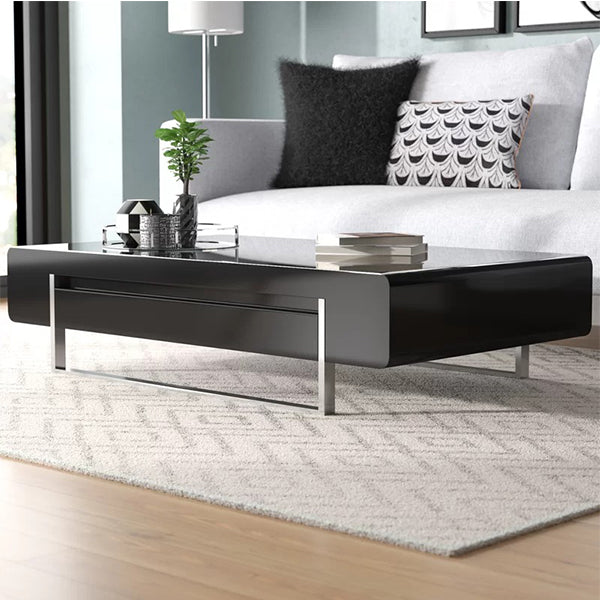 Sam black coffee table with glossy PU top styled beside a sofa in a modern living room