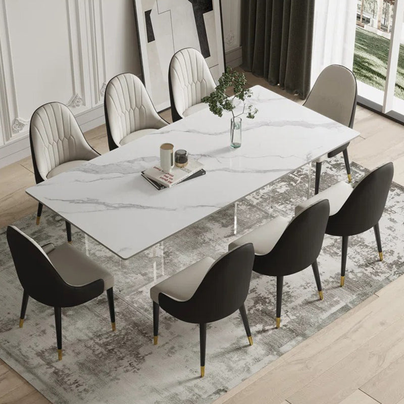 Satvario stone 8-seater dining table set with marble top and upholstered leatherette chairs.
