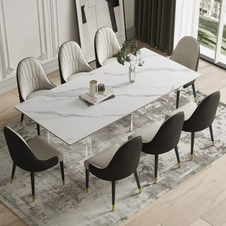 Satvario stone 8-seater dining table set with marble top and upholstered leatherette chairs.