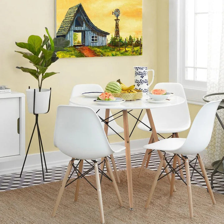 Compact 4 seater dining table set with round table and space-saving chair storage design.