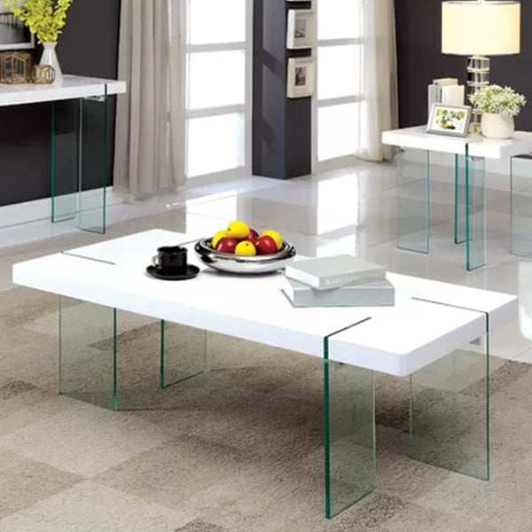 A white coffee table with a transparent acrylic edge, placed on a carpeted floor in a room with a window and decorative items on top.