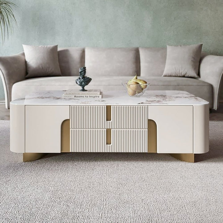 living room with beige Vista coffee table featuring a stone surface and elegant gold accents