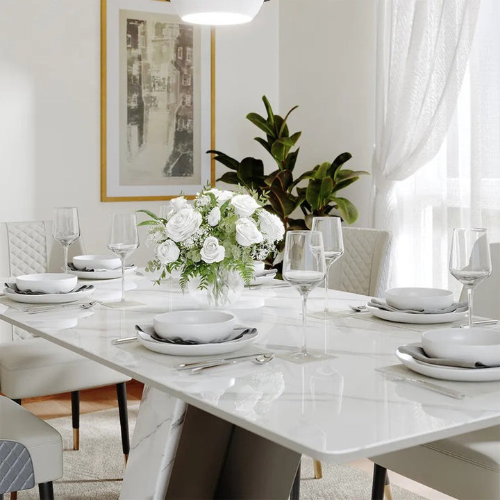 Elegant dining room with a dining table set for eight, a modern centerpiece, and modern decor.