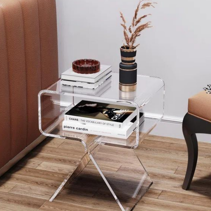 Clear acrylic end table styled as nightstand in bedroom