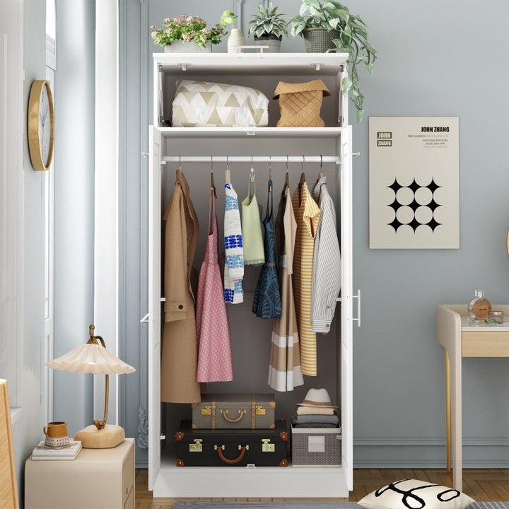 White modular wardrobe with clothes and bags inside, surrounded by a room with a lamp, plant, and wall art.