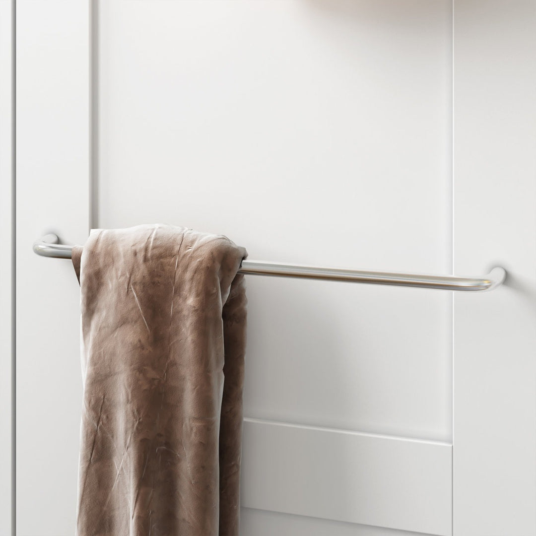 Brown towel hanging on a silver towel rack against a white wardrobe.