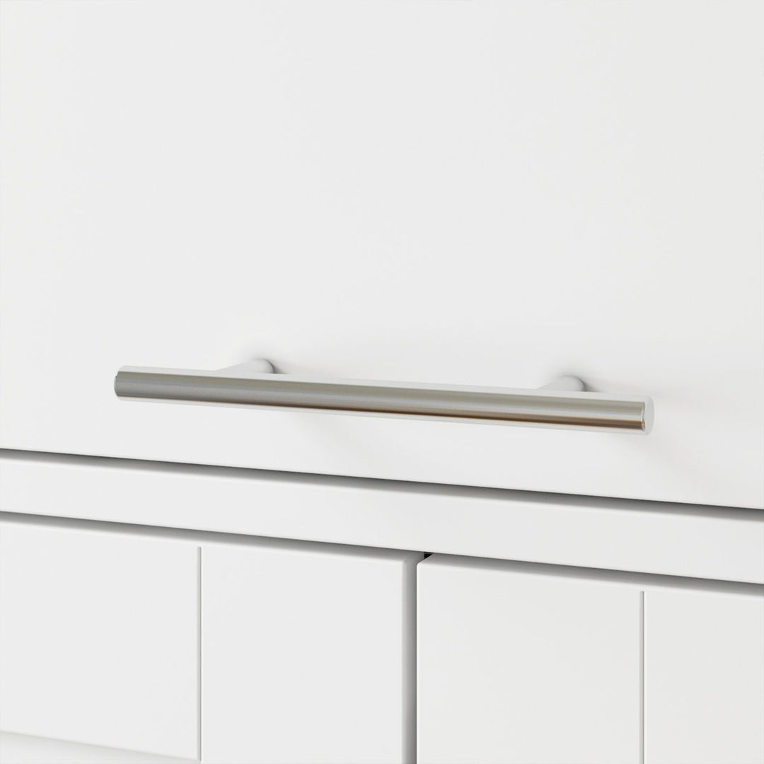 Close-up of a white cabinet with a silver handle on a white wardrobe