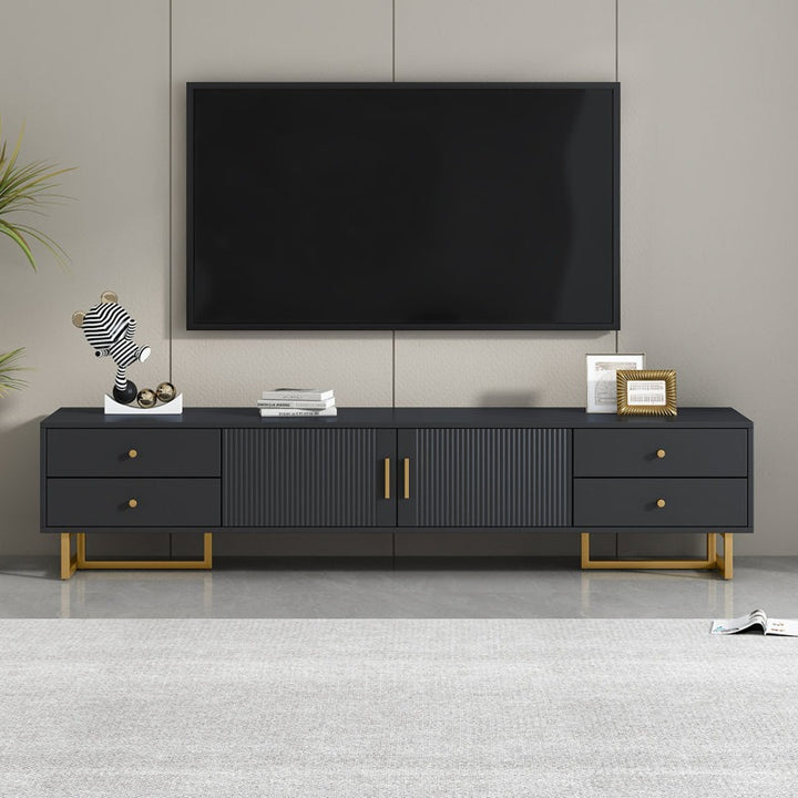 A large black TV stand with a wave-groove pattern and T-shaped metal frame. It features dual-style metal handles and multiple storage units, including drawers and a cabinet.