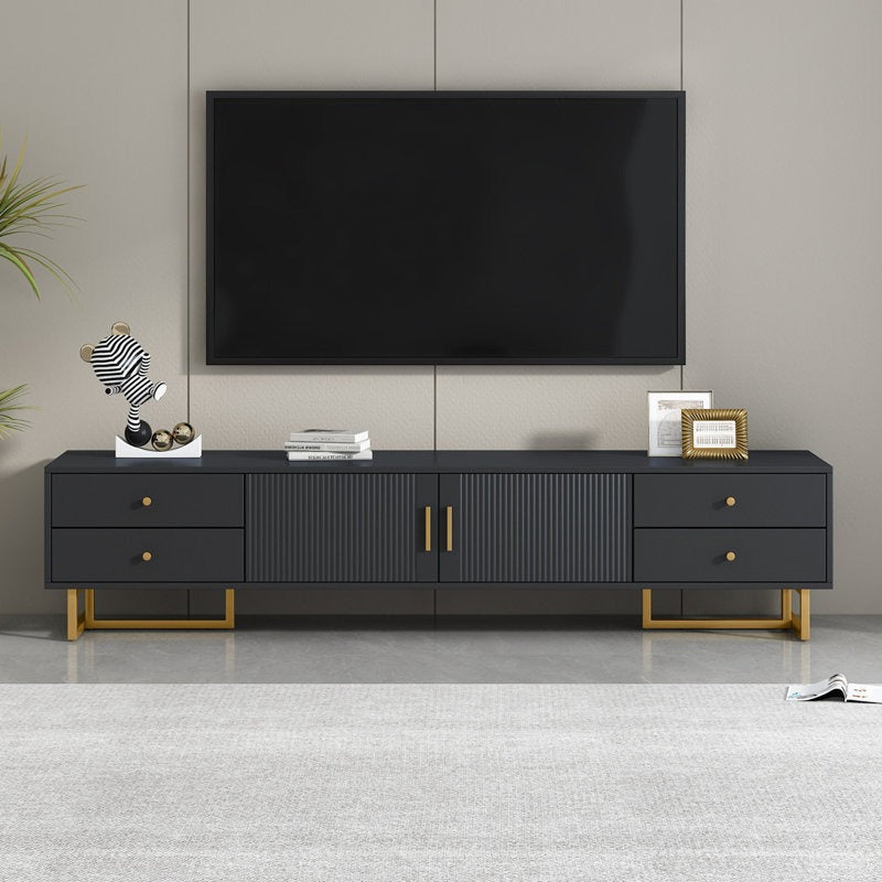 A large black TV stand with a wave-groove pattern and T-shaped metal frame. It features dual-style metal handles and multiple storage units, including drawers and a cabinet.