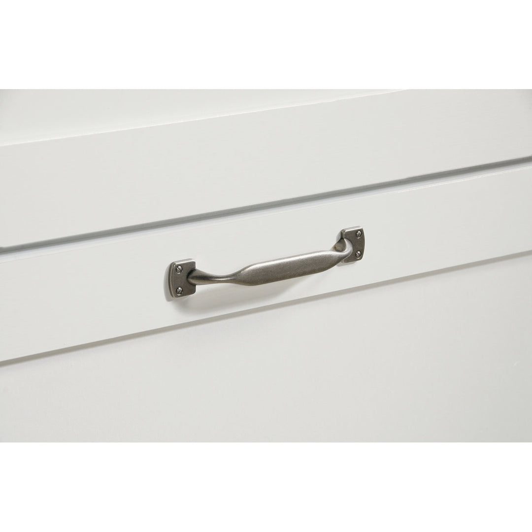Metal handle on a white drawer