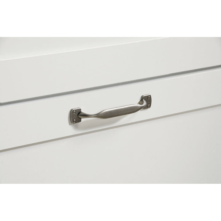 Metal handle on a white drawer