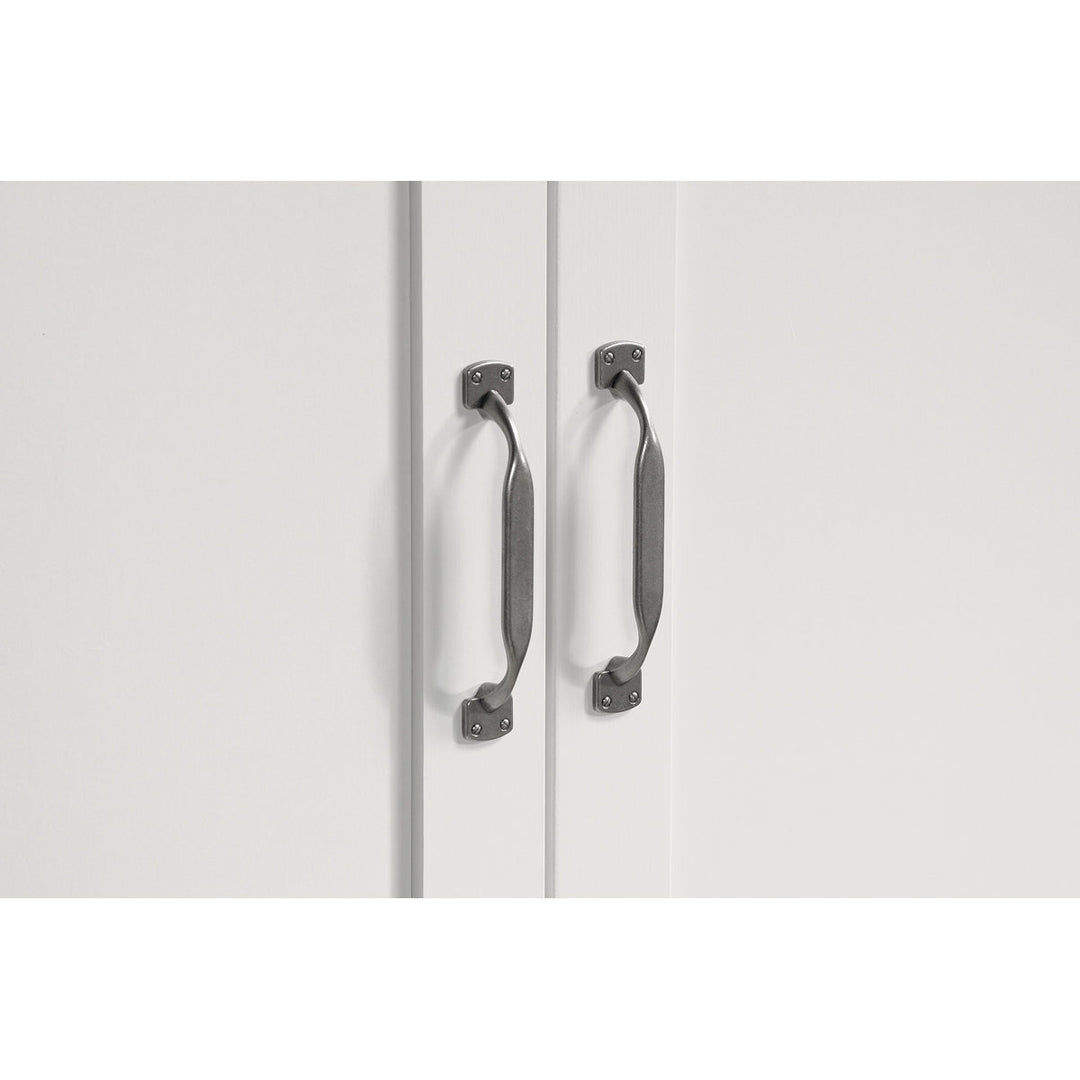 White wardrobe doors with metallic handles on a white background