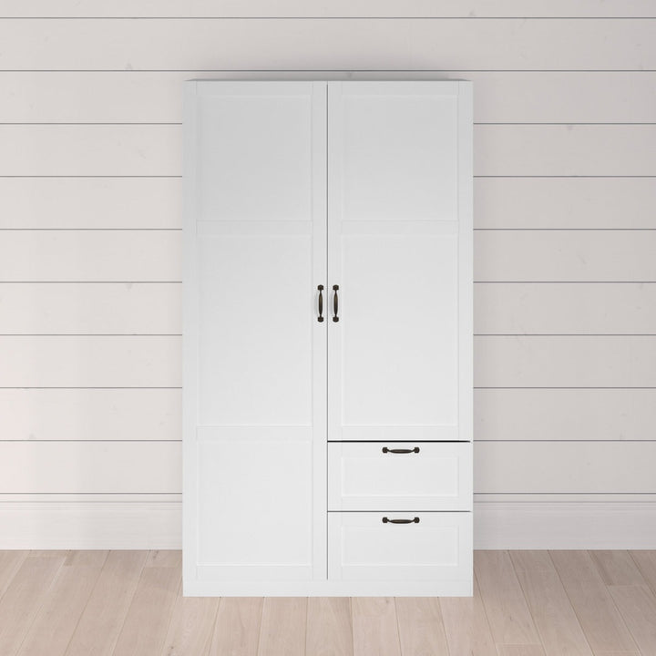 White wardrobe with black handles against a light wooden paneled wall.