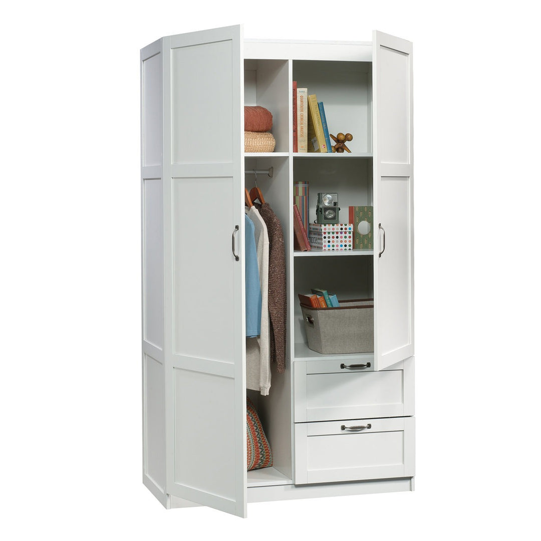 Modern white wardrobe with open doors showing clothes and items inside on a white background