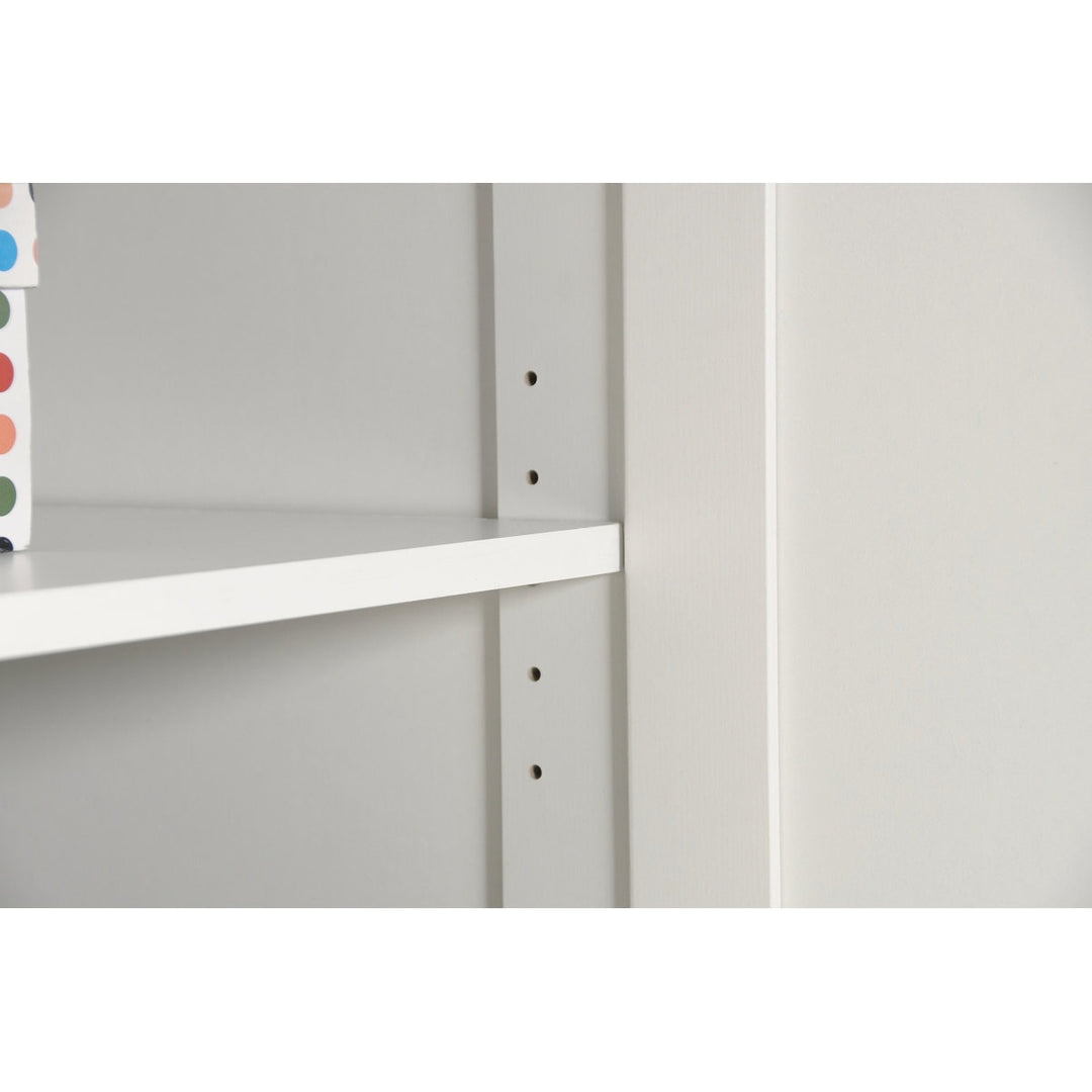 White shelving unit with a single shelf against a plain background