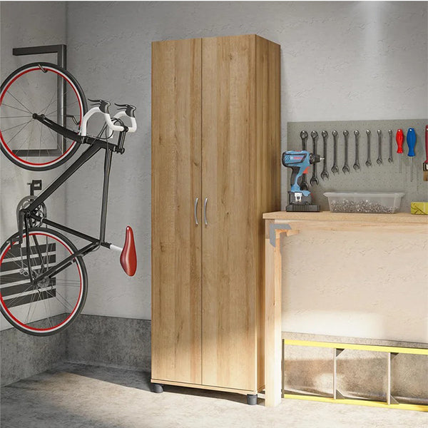 A beige two-door wardrobe with silver metal handles is mounted on a wall, with a bicycle hanging on the wall above it and tools on the counter in the background.