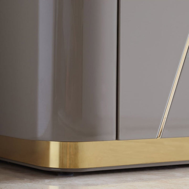 Gold-tone metal base of grey Vint sideboard