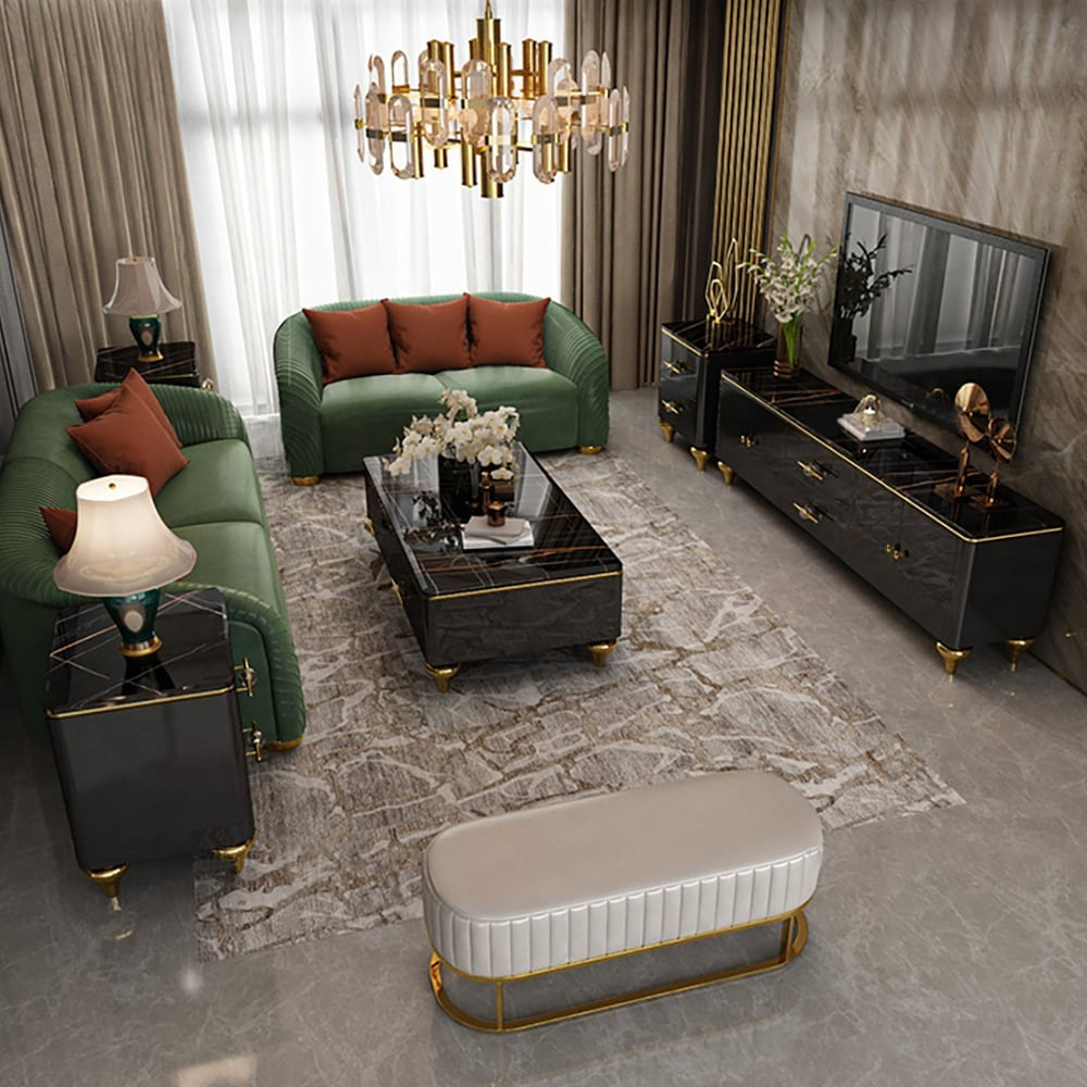 Stylish black coffee table with marble top and gold-colored legs placed in the center of the living room with a green sofa and black TV unit.