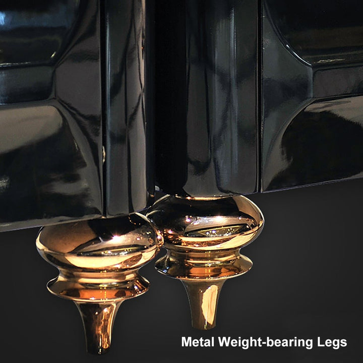 Stylish gold-colored metal legs of black coffee table