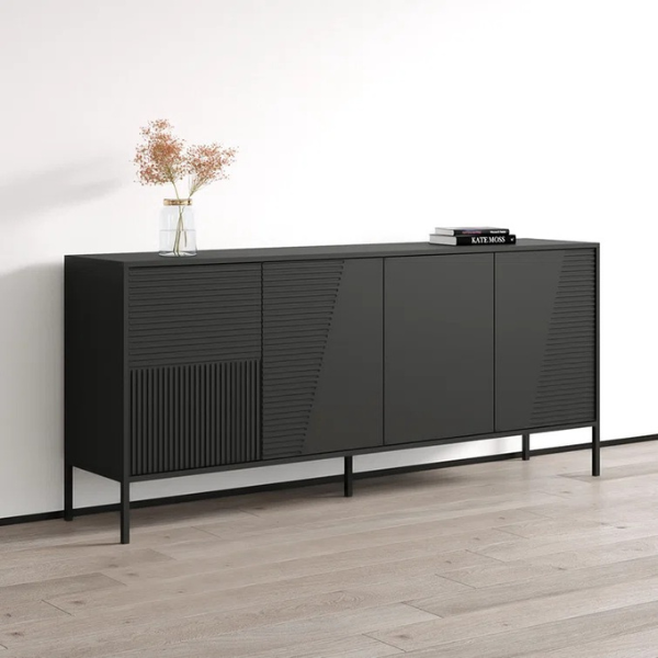A small black sideboard and cabinet with metal accents, featuring soft-close operable shutters, placed against a wall on a wood floor, with a vase and books on top.