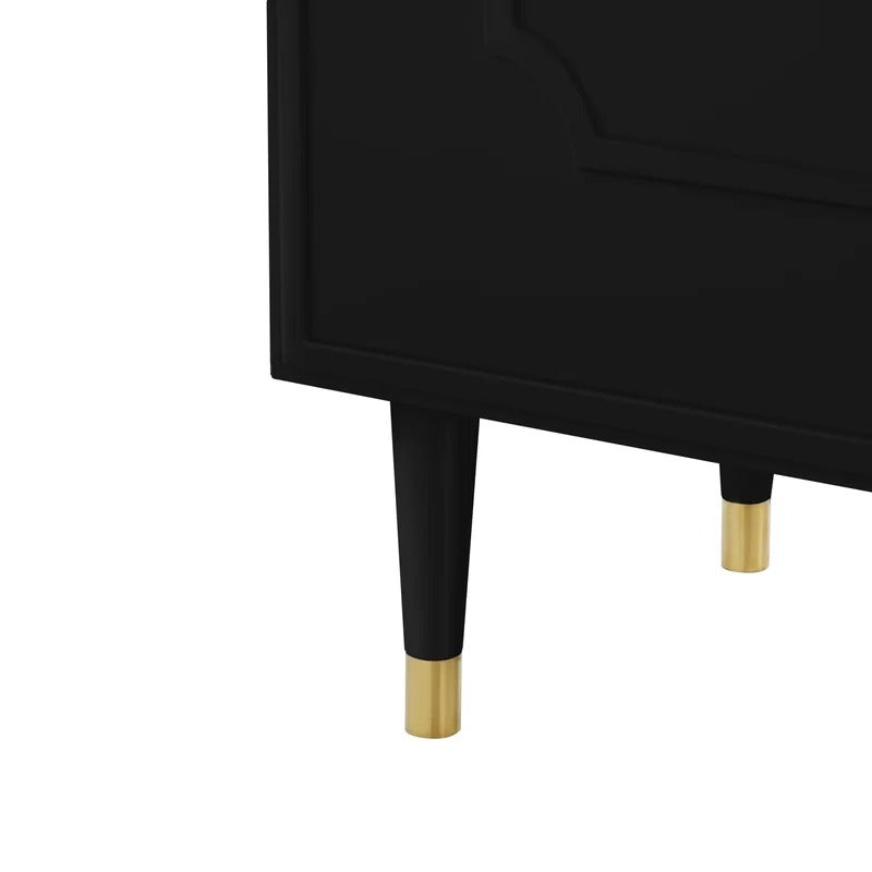 golden legs of a stylish black cabinet