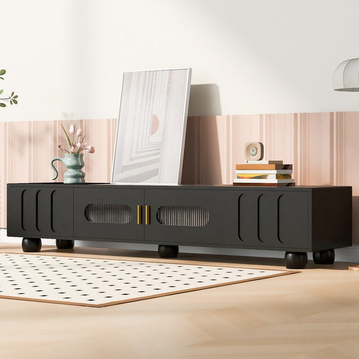 A sleek black Stic TV stand with dual doors and two drawers, featuring an elegant arched design with Changhong tempered glass. The TV stand is positioned in a modern living room setting.