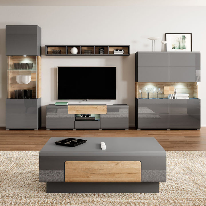 Modern living room with black and wooden furniture, including a TV stand and coffee table.