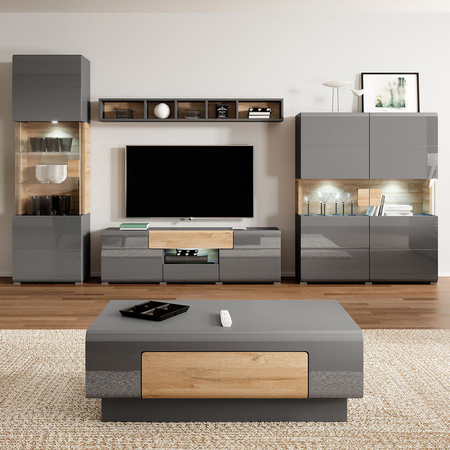 Modern living room with black and wooden furniture, including a TV stand and coffee table.