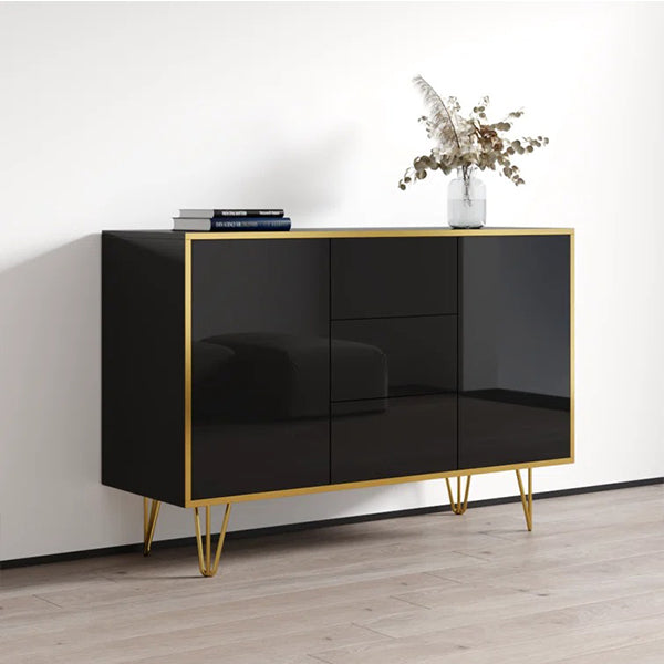 Luxury black sideboard and cabinet with gold metal legs, featuring openable shutters and a flatware drawer, placed against a white wall with a decorative item on top.