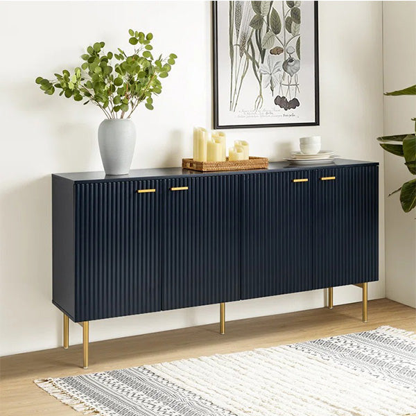 A navy blue vertical line sideboard and cabinet with gold handles and embossed texture, placed in a room with a plant, candles, and a decorative bowl.