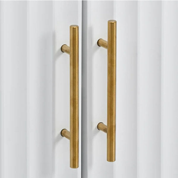 detailed view of golden handles on a white shutter of sideboard