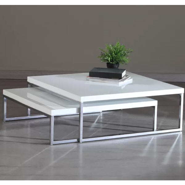 A modern white coffee table with stainless steel legs and a high gloss PU paint finish, featuring a small potted plant on top.