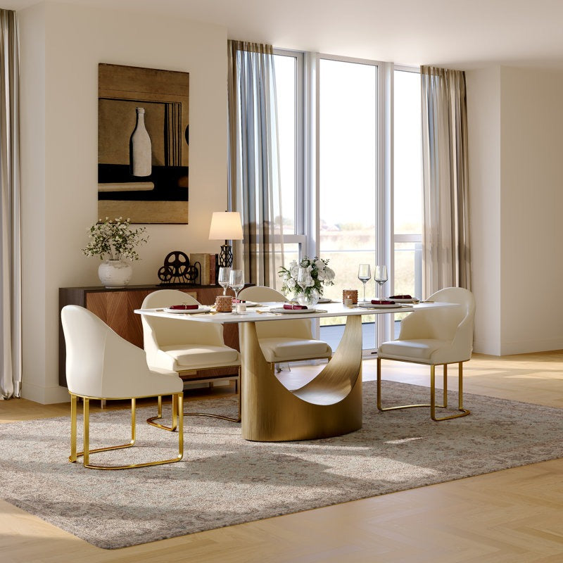 Modern dining room with a gold dining table and white chairs.
